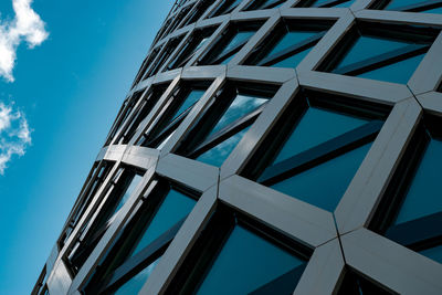 Low angle view of modern building against blue sky