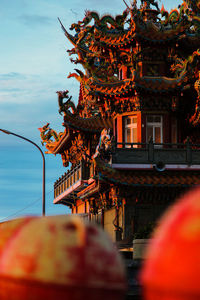 Traditional building by street against sky in city