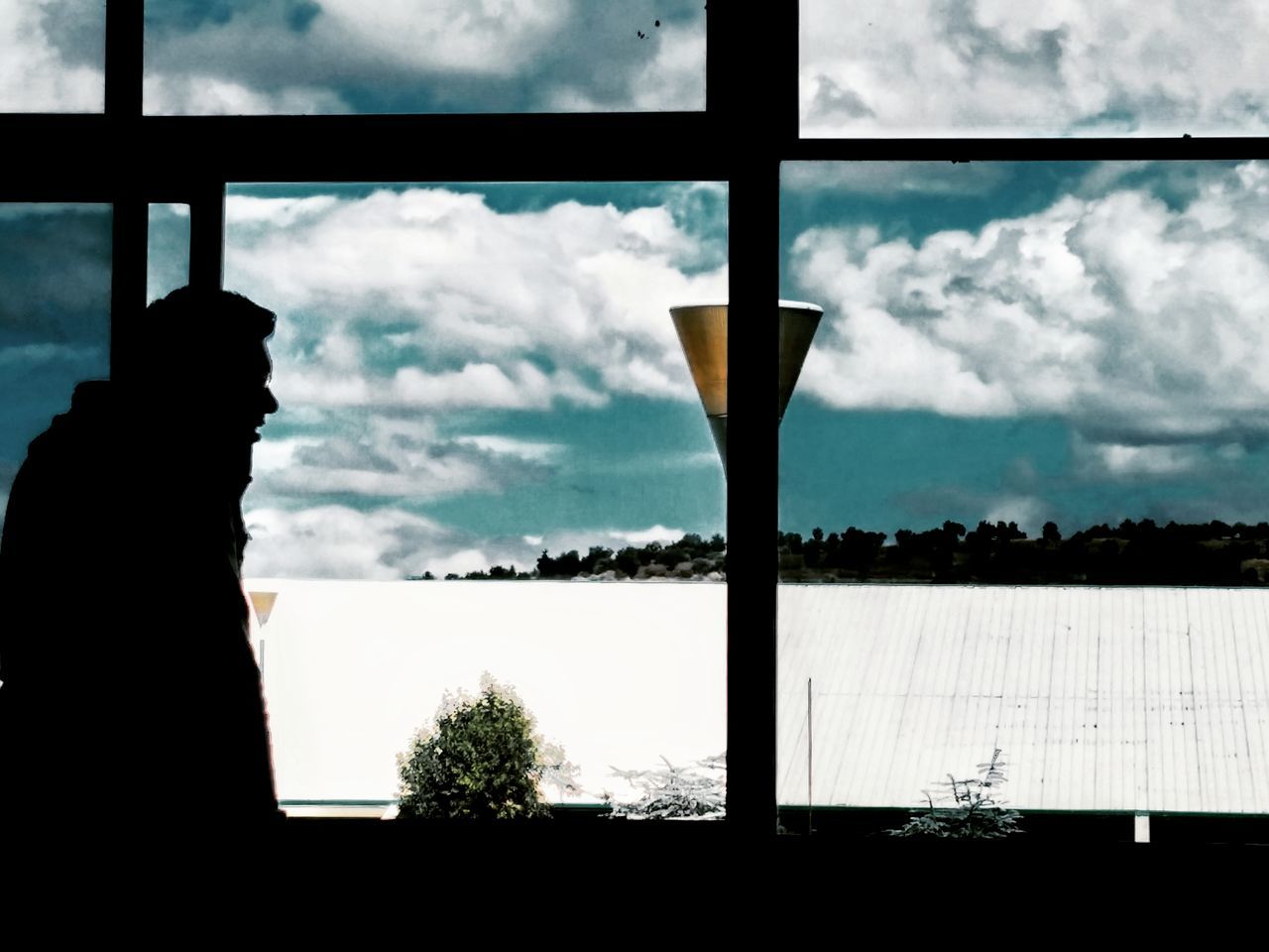 CLOSE-UP OF SILHOUETTE MAN AGAINST SKY SEEN THROUGH WINDOW