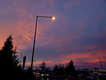 Street lights against sky during sunset