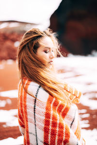 Portrait of woman looking away during winter