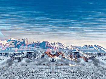 High angle view of snowcapped mountains against sky