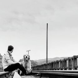 Woman sitting against sky