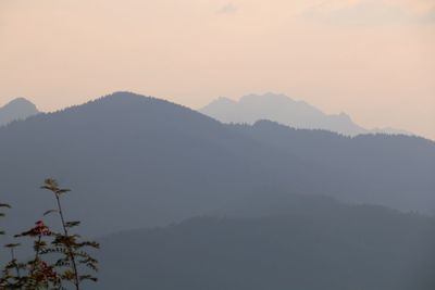 Scenic view of silhouette mountains against sky during sunset