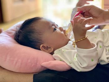 Midsection of cute baby girl at home