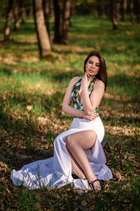 Portrait of woman sitting on field