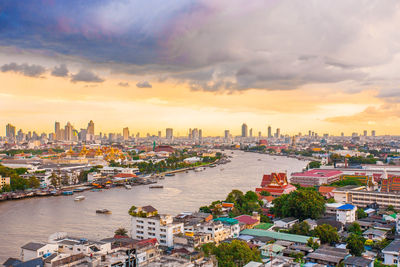 High angle view of buildings against cloudy sky during sunset