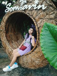 Full length of young woman standing in tunnel