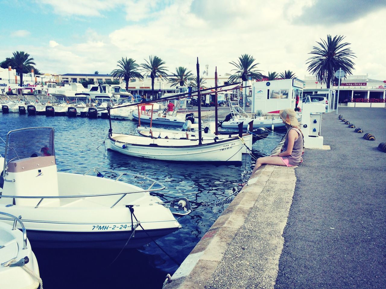 nautical vessel, moored, transportation, boat, mode of transport, water, sky, sea, cloud - sky, harbor, tree, cloud, palm tree, beach, incidental people, day, mast, travel, outdoors, sailboat