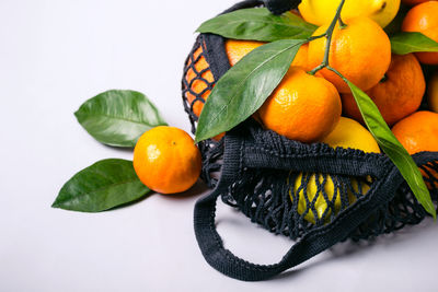 Healthy food and zero waste concept. set of citrus in mesh textile bag.