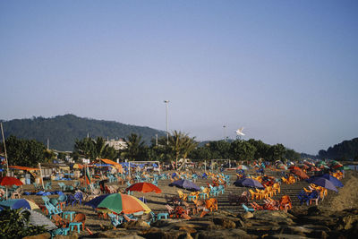 Crowd at beach against clear sky