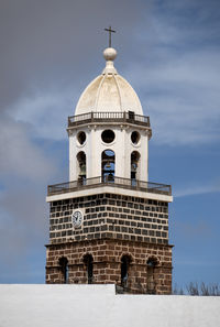 Low angle view of churchtower against sky