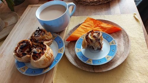 High angle view of breakfast on table. dessert from close-up in plates on the table. wooden base.