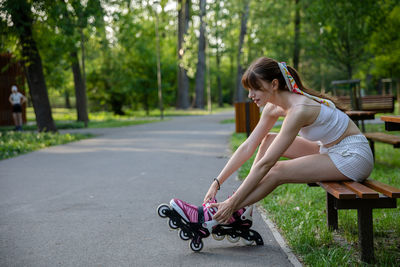 Side view of young woman exercising in park