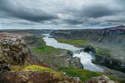 Scenic view of waterfall against sky