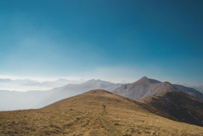 Scenic view of mountains against blue sky