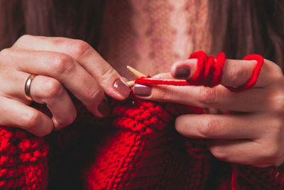 Midsection of woman knitting wool