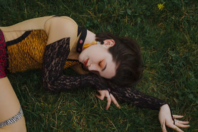 High angle view of woman lying on field