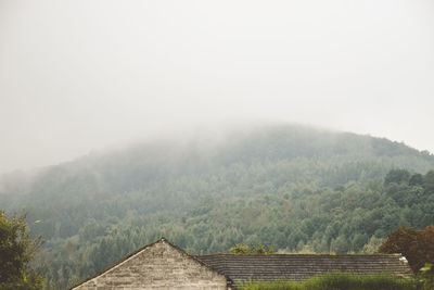 Scenic view of mountains against sky during foggy weather