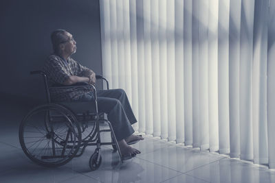 Man sitting on wheelchair at home