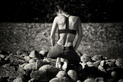 Rear view of woman on rocks