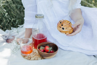 High angle view of woman holding drink on table