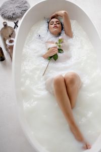 Beautiful woman sitting in bathtub