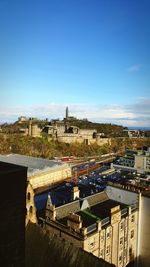 View of cityscape against blue sky