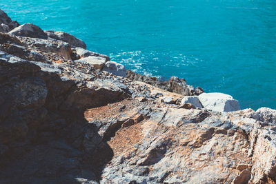 High angle view of rock formation by sea against sky