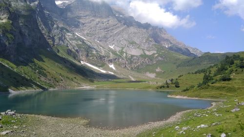 Scenic view of lake and mountains against sky