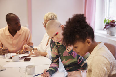 Coworkers sitting at business meeting in meeting room