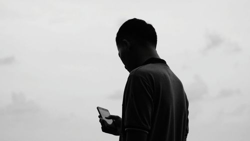 Rear view of man standing against sky