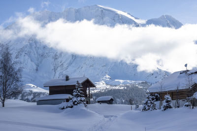 Scenic view of snow covered mountains against sky