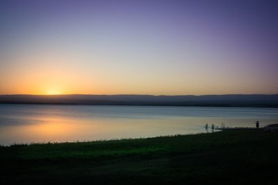 Scenic view of lake against sky during sunset