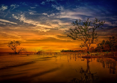 Scenic view of lake against sky during sunset