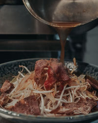 Close-up of meat in cooking pan