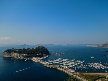 Aerial view of island and boats in harbor