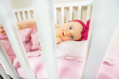 High angle view of baby boy lying on bed at home