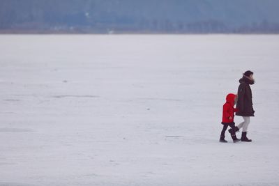 Full length of man standing on snow covered land