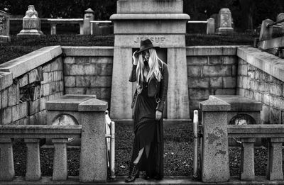 Woman a witch standing in a graveyard 