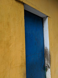 Blue door, yellow wall, streets of hoi an, vietnam.