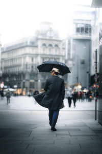 Rear view of a man walking on street