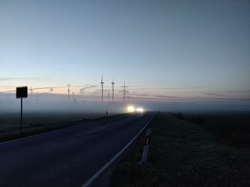 Road against clear sky at sunset