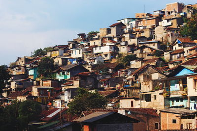 Houses in town against sky