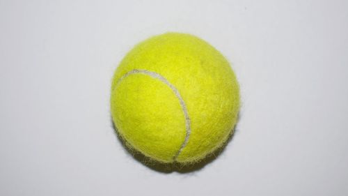 Close-up of yellow ball on white background