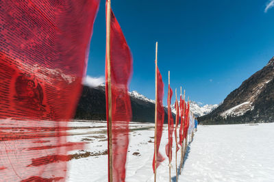 Panoramic view of icicles and mountains against clear blue sky