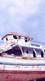 Abandoned ship in sea against sky