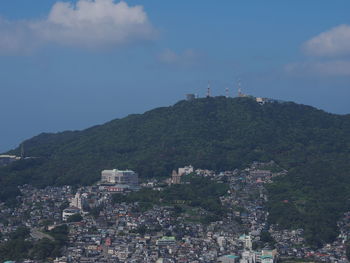 High angle view of townscape by mountain against sky