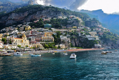 Buildings at amalfi coast against mountain