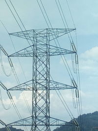 Low angle view of electricity pylon against sky